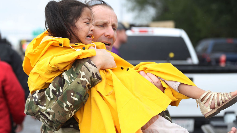 Bush School faculty member Richard MacNamee carries a girl to safety from the flooding of Hurricane Harvey on August 30, 2017 in Port Arthur, Texas. (Photo by Joe Raedle/Getty Images. Reposted from Texas A&M University)