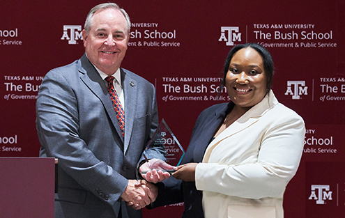 Photo of Cherrelle Duncan accepting her award from Dean Mark Welsh
