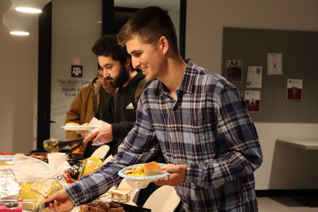 Picture of SGA President Michael Pack fills his plate with Thanksgiving favorites. 