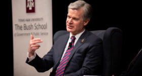 Christopher Wray talks to the crowd from the stage