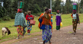 Kinigi, Rwanda - october 2, 2015: a group of women in traditional dress, coming home from work. One of them draws their attention.