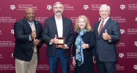 Dr. Roger Reese receiving 41 award from Bush School Dean Frank Ashley
