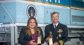 on the left is Diana Pérez Gomez ’00, on the right is Capt. Jeff W. Benson ’03