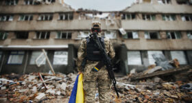 Ukrainian military woman with the Ukrainian flag in her hands on