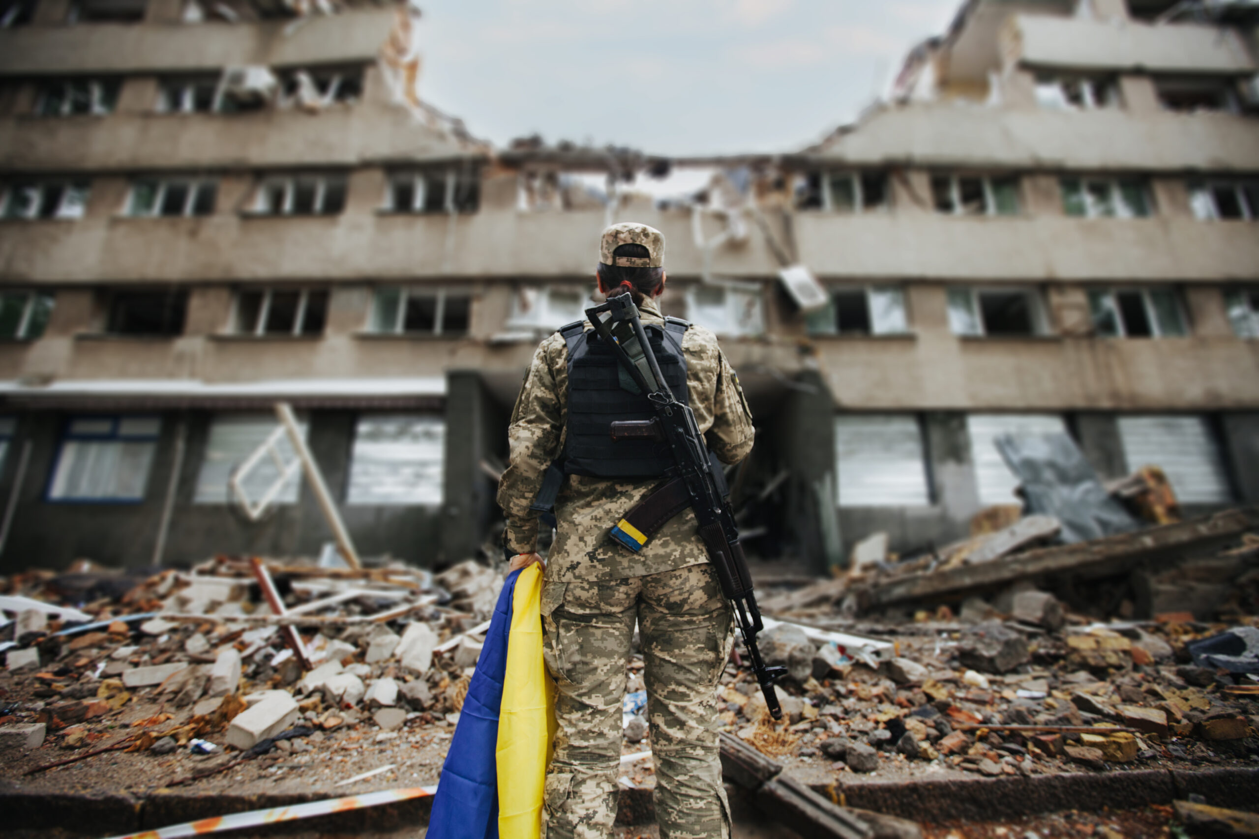 Ukrainian military woman with the Ukrainian flag in her hands on