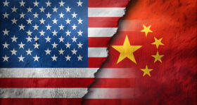 Ripped US and Chinese flags symbolize tense, competitive relations. Contrasting colors and textures highlight divided US-China relationship.