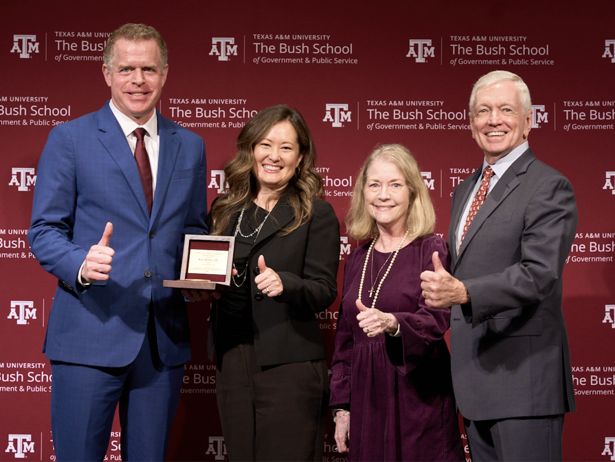A photo of Aric Short; his wife, Tanya Pierce; and the creators of the 41 Award, Linda Vincent and Stephen Vincent '73. They are holding the 41 Award and giving a thumbs up.