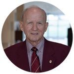 Randy House wearing a maroon blazer, light shirt and striped maroon tie