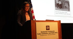 Dr. Teague standing at the podium.